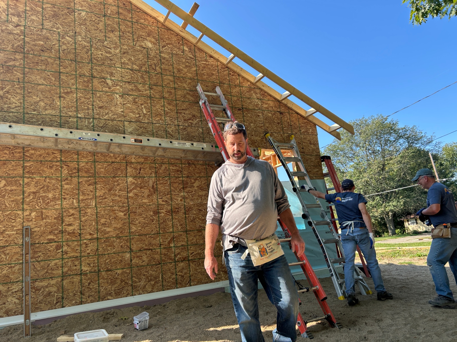 Volunteers framing a house at the build site